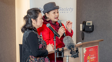 2 females taking at the podium