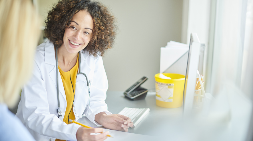 Friendly doctor chatting with patient.