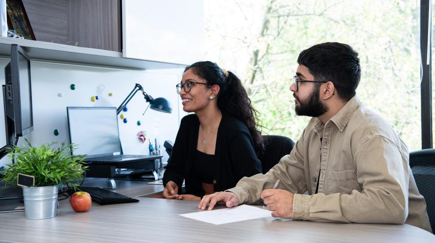 two people looking at computer screen
