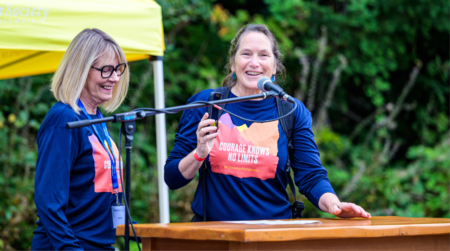 Sue Oakey speaking on stage at the Climb for Alzheimer's 2024