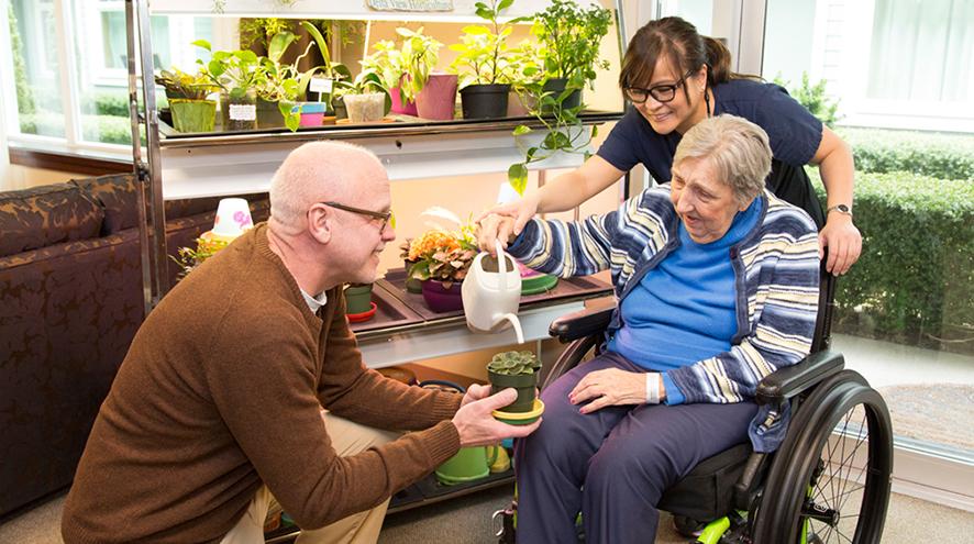 caregivers with woman in wheelchair