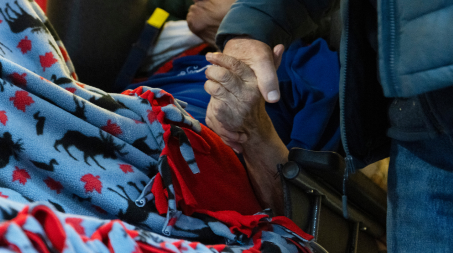 Photo of family members holding hands