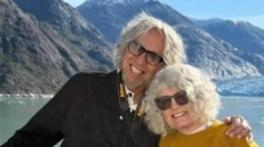Tobias and Martha standing in front of water and mountains