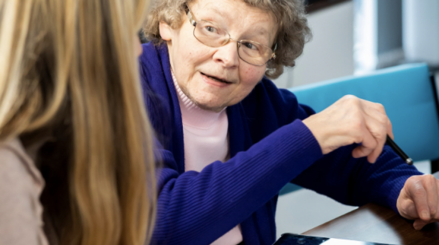 A woman organizing her medication with a nurse