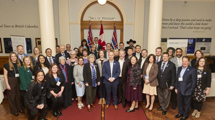 A large group of staff, MLAs, guests in the Hall of Honour at BC Legislature