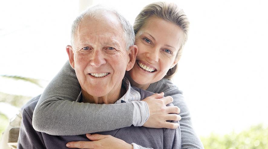 Man and woman smiling at the camera.