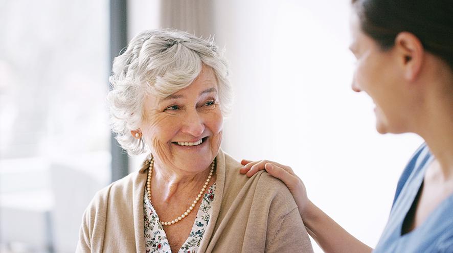 Older woman smiling at a younger woman