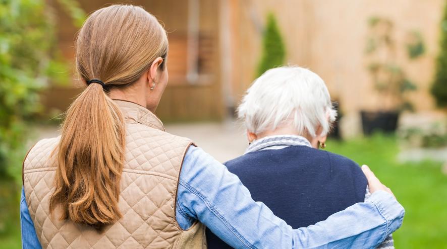 Younger woman with her arm around an older woman