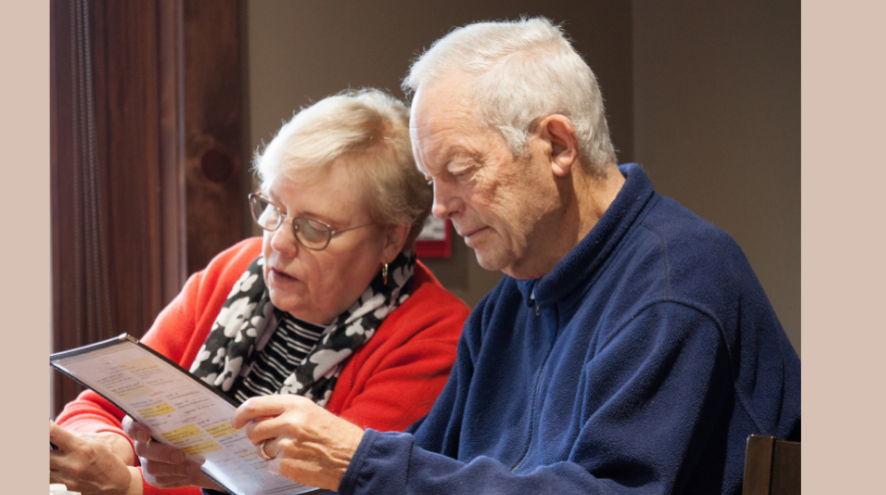 senior couple looking at menu