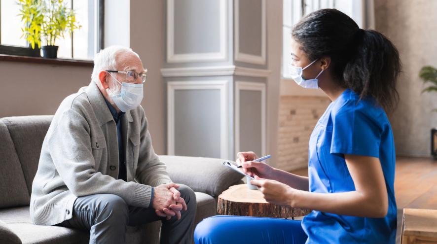 man and PSW with masks sitting together