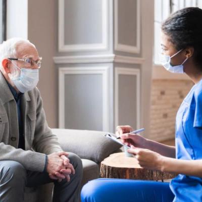 man and PSW with masks sitting together