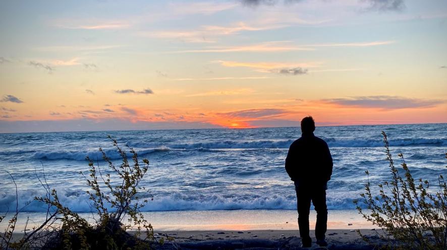 Man looking at sunset on Lake Huron