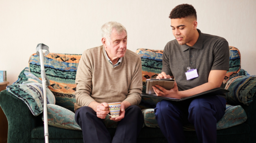 senior man with support worker at home