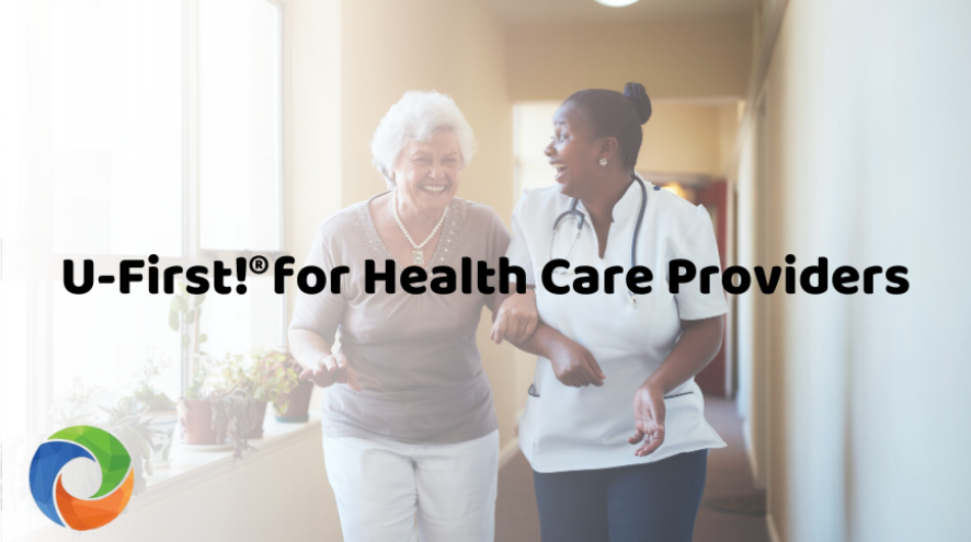 Female nurse walking down hallway with female patient