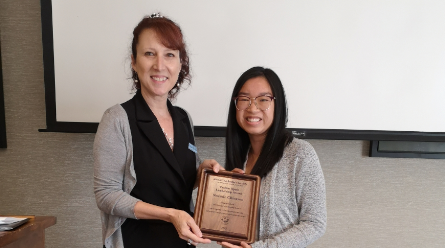 Noemie being presented with award by ASNB staff Marie-Paule