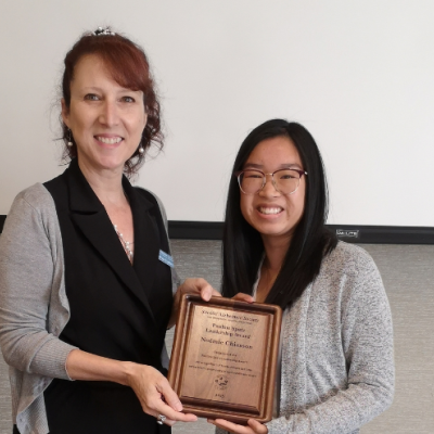 Noemie being presented with award by ASNB staff Marie-Paule