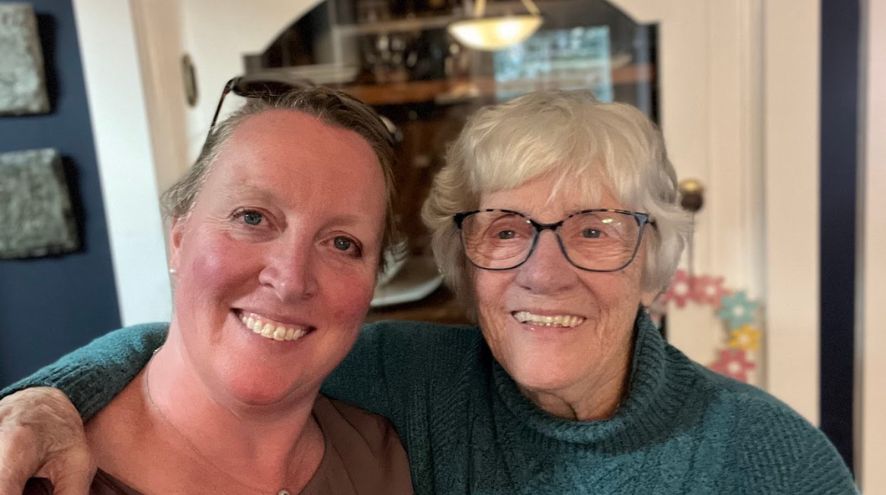 An adult woman and senior woman together smiling