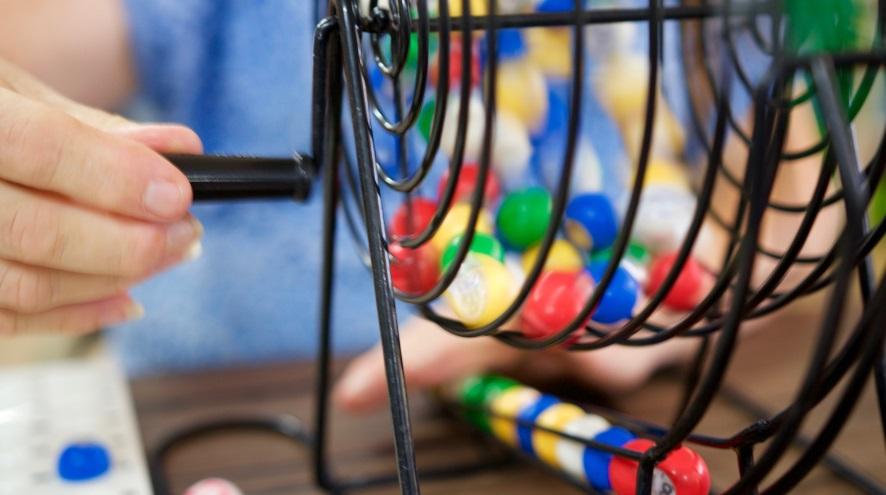 Close up of hand spinning bingo ball cage