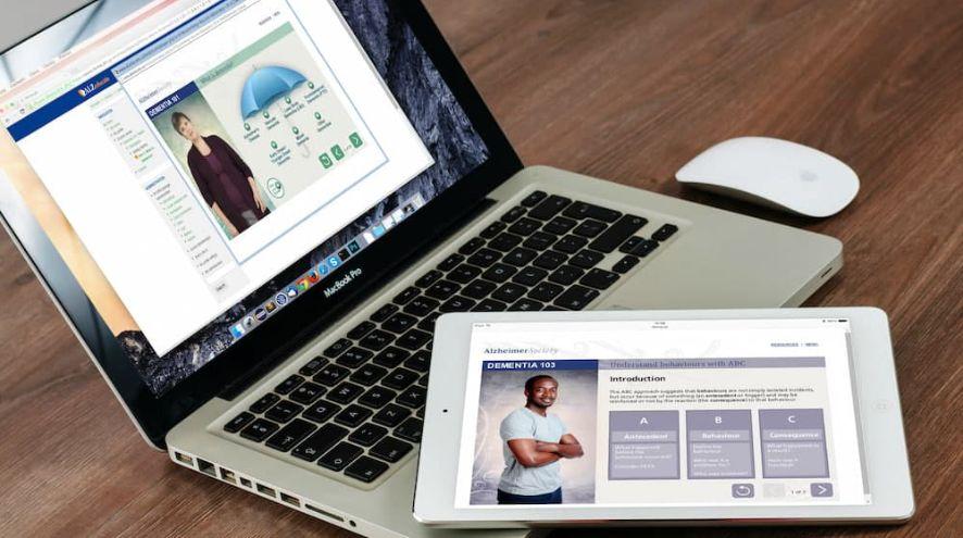 A laptop and tablet displaying dementia-related course material
