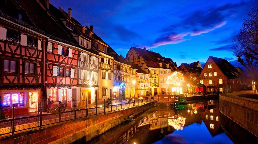 buildings beside a canal at dusk