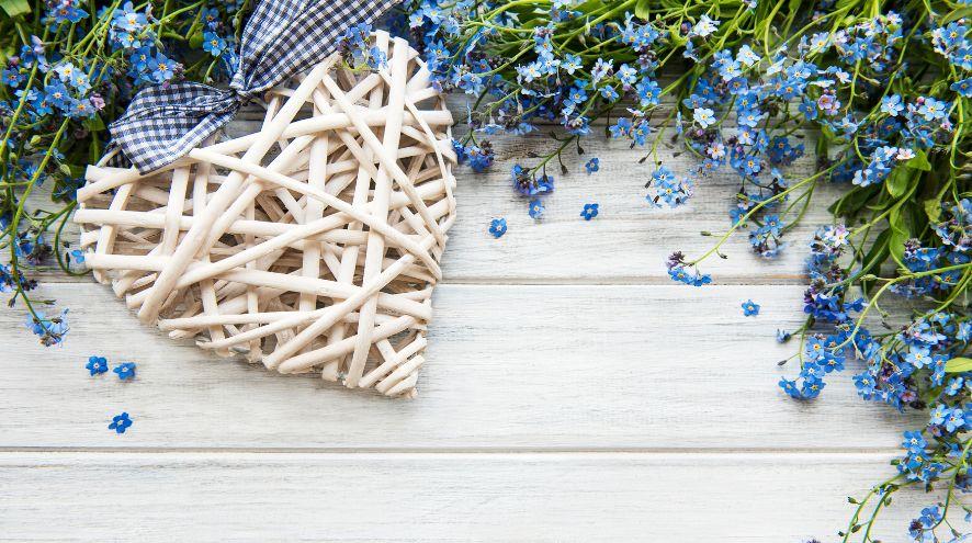 Wicker heart amidst an arrangement of forget-me-nots