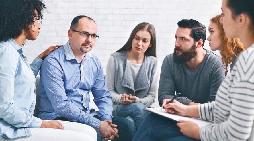 A group of middle-aged people sitting and talking