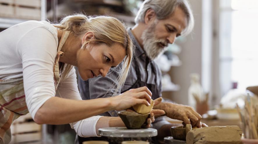 Two people making pottery