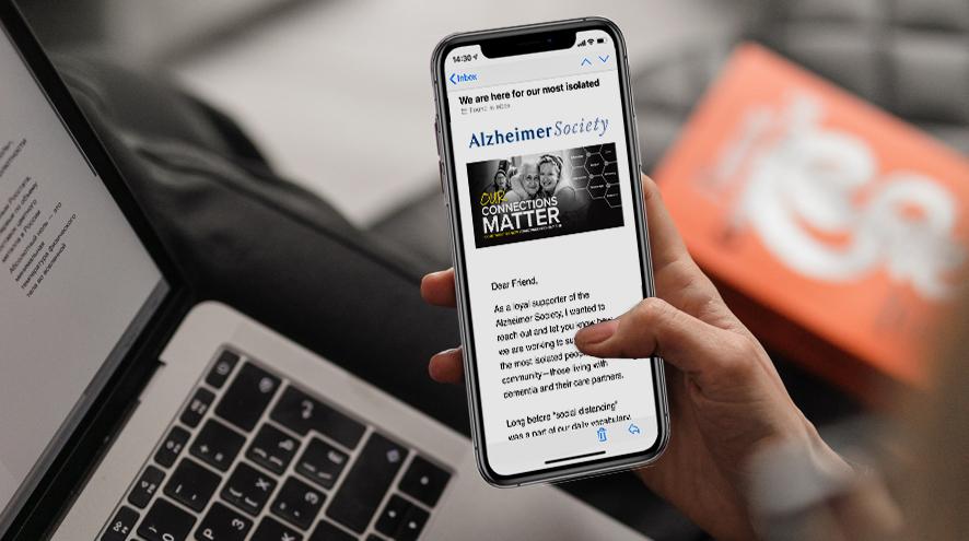 A person reading an enewsletter on their phone.