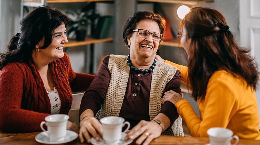 A group of people talking and smiling at a table