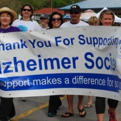 People holding a banner at the Walk for Alzheimer's