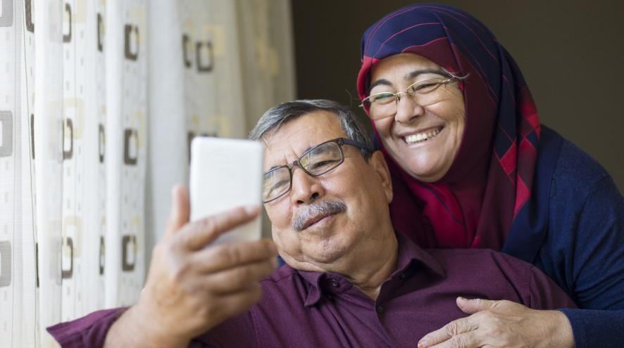 Senior couple looking at a phone together,