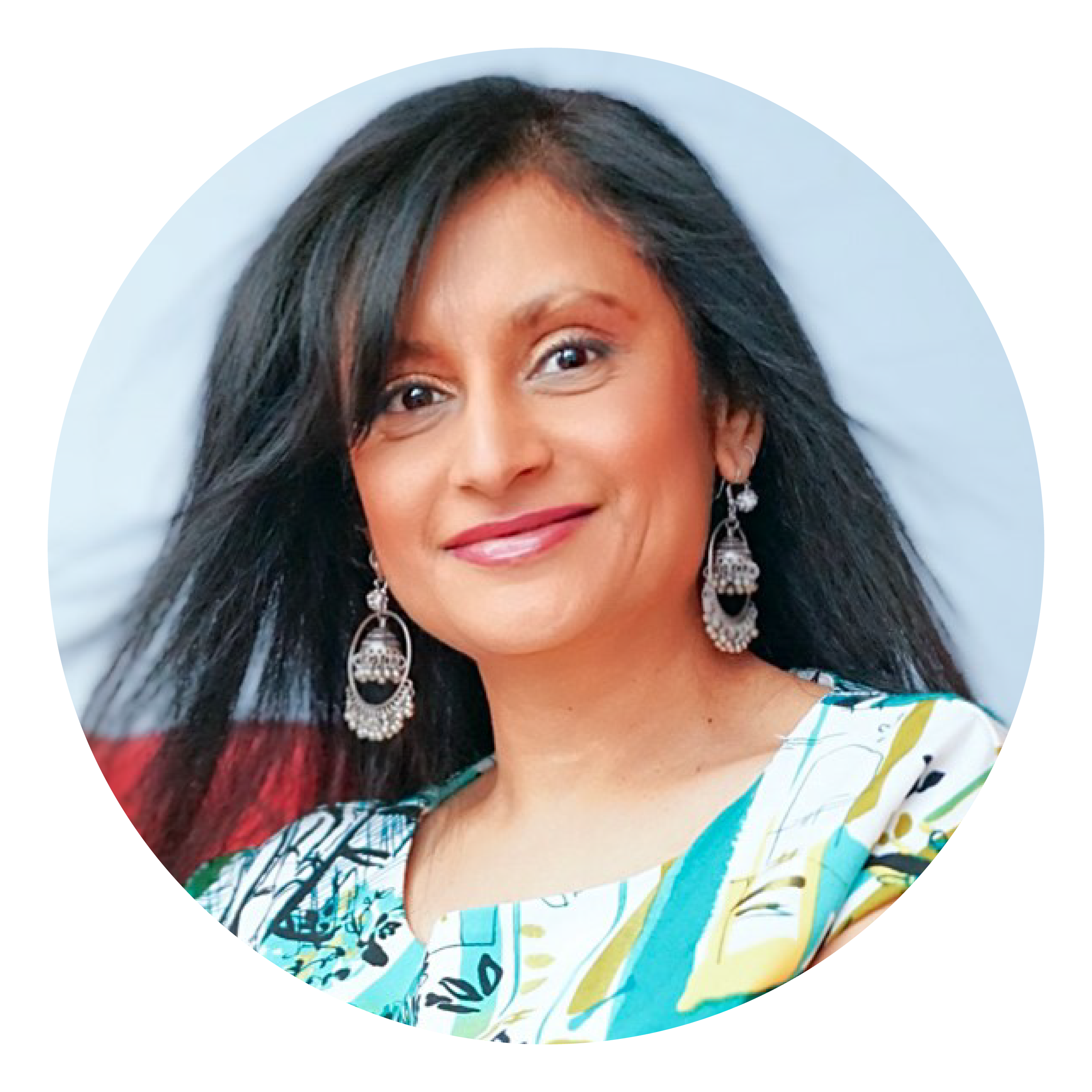 A smiling woman with long dark hair wearing a colourful top