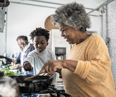 A family cooking at a stove