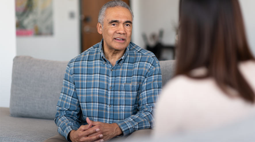 Older man speaking to younger woman