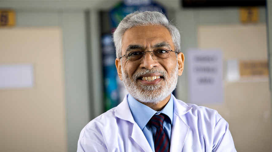 A midlife man in glasses and a white doctor's coat