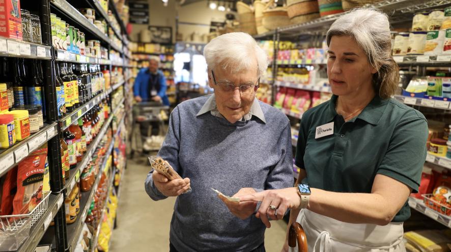 Photo of grocery store staff helping a member of the public