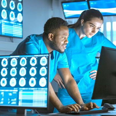 Two researchers looking at a computer in the lab.