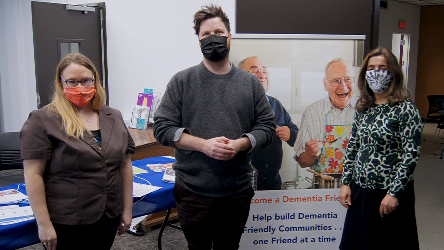 Attendees in front of the Alzheimer Society table at the reception