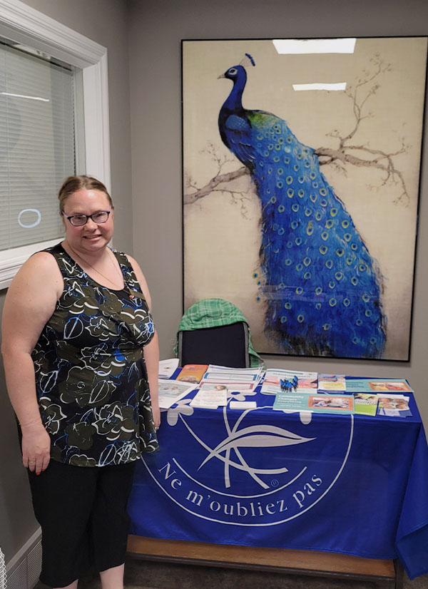 Our Dementia Community Coordinator in front of our display table at Deer Park Villa.