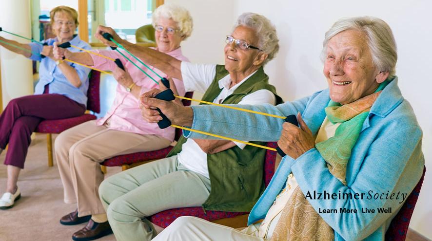 A group of yoga participants smiling and enjoying their class.