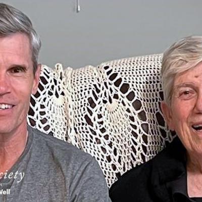 Dr. Brent Chappell sitting on a couch with his father. Both are smiling.