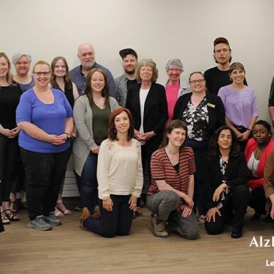 Members from the Saskatchewan Population Health and Evaluation Research Unit and collaborating organizations involved in the Dementia Supports in Rural Saskatchewan project gathered in three rows, smiling for the photo.