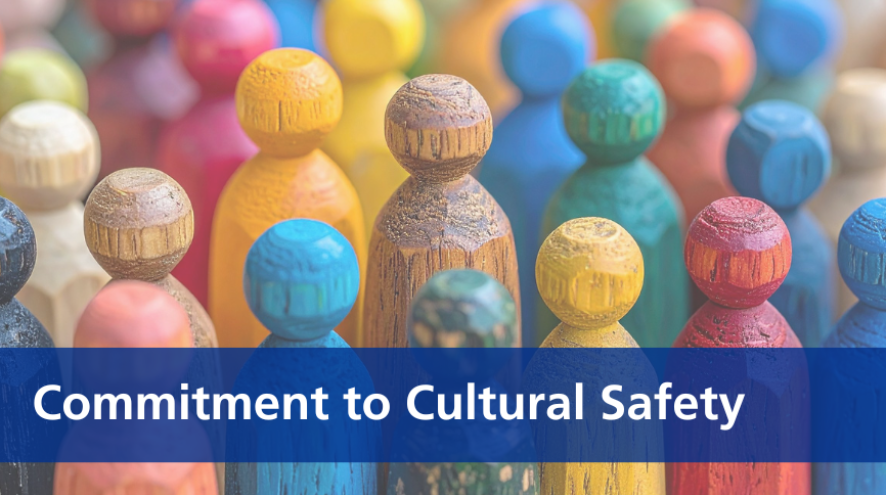 a lot of multi-coloured wooden figures with a banner across the bottom of the image that reads "Commitment to Cultural Safety"