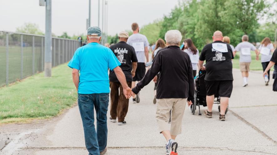 Photo of people walking away from the camera.