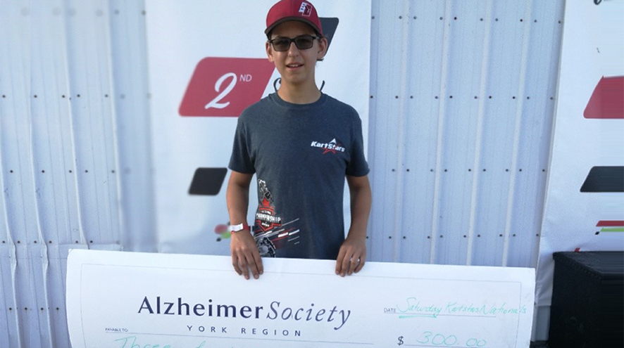 picture of Jake Cowden holding a cheque