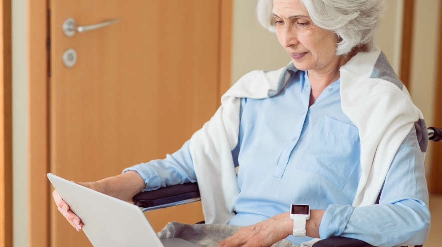 Senior in wheelchair on a laptop