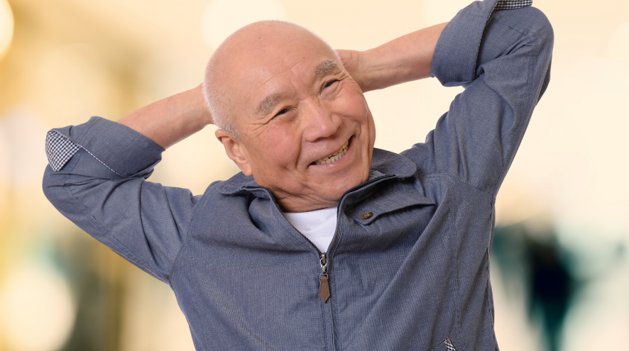 Senior man stretches and smiles 