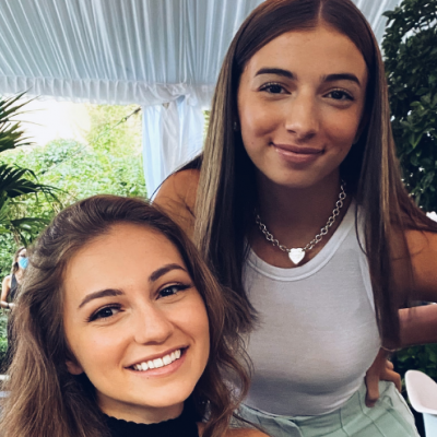 Picture of Stacey and Marianna Speranza, founders of The Business Casual, in a covered room with plants in the backgroun