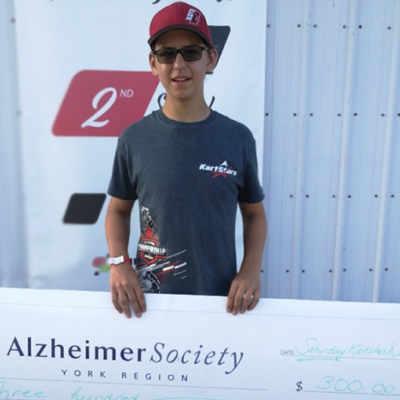 picture of Jake Cowden holding a cheque